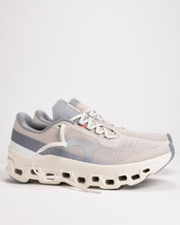 Side view of Men’s On Cloudmonster 1 running shoe in Pearl/Ivory showing CloudTec® cushioning