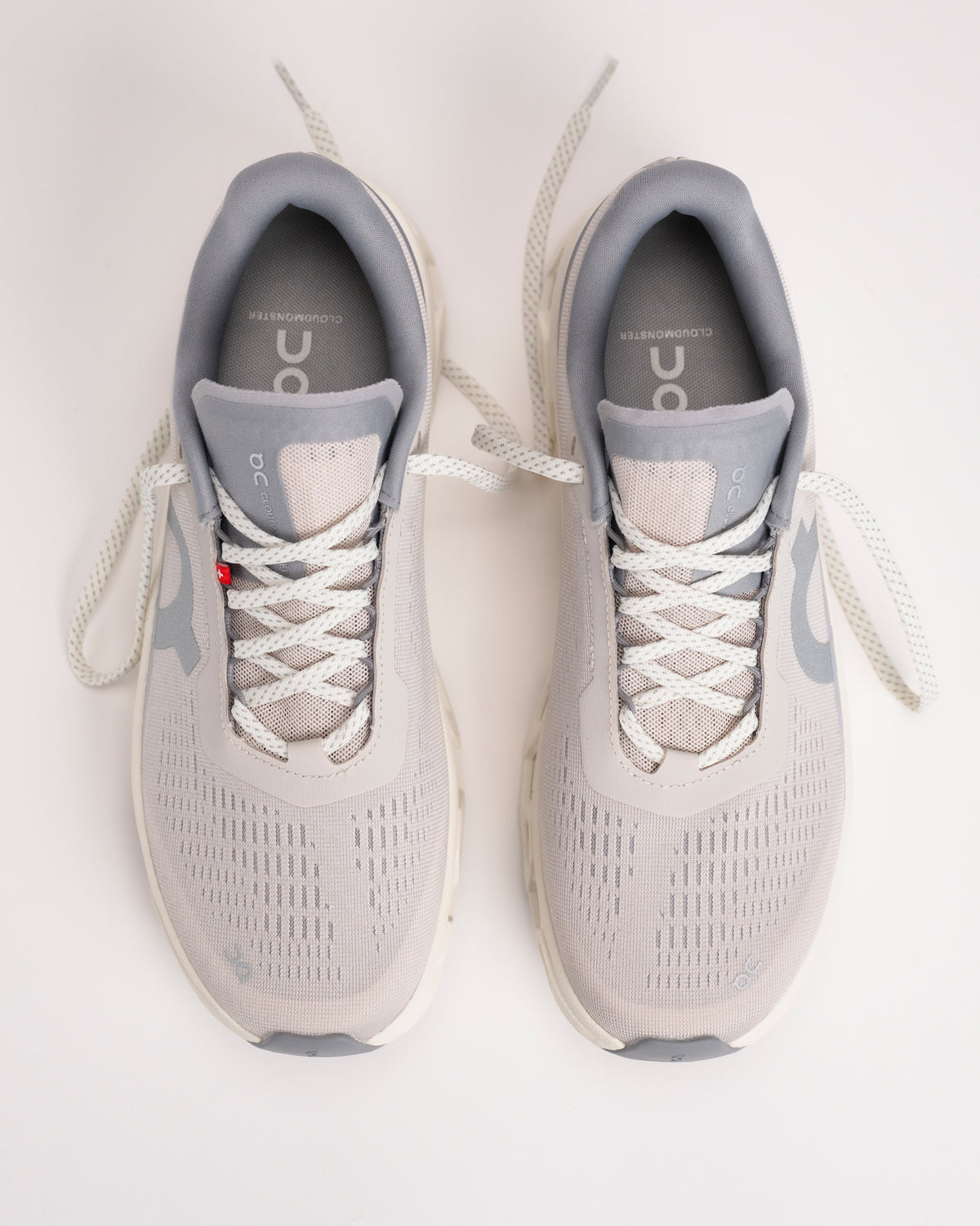 Top-down view of Men’s On Cloudmonster 1 Pearl/Ivory with mesh upper and hidden eyelet lace detail