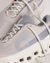 Close up view of On Cloudmonster 1 men’s shoe highlighting logo detailing and lightweight upper