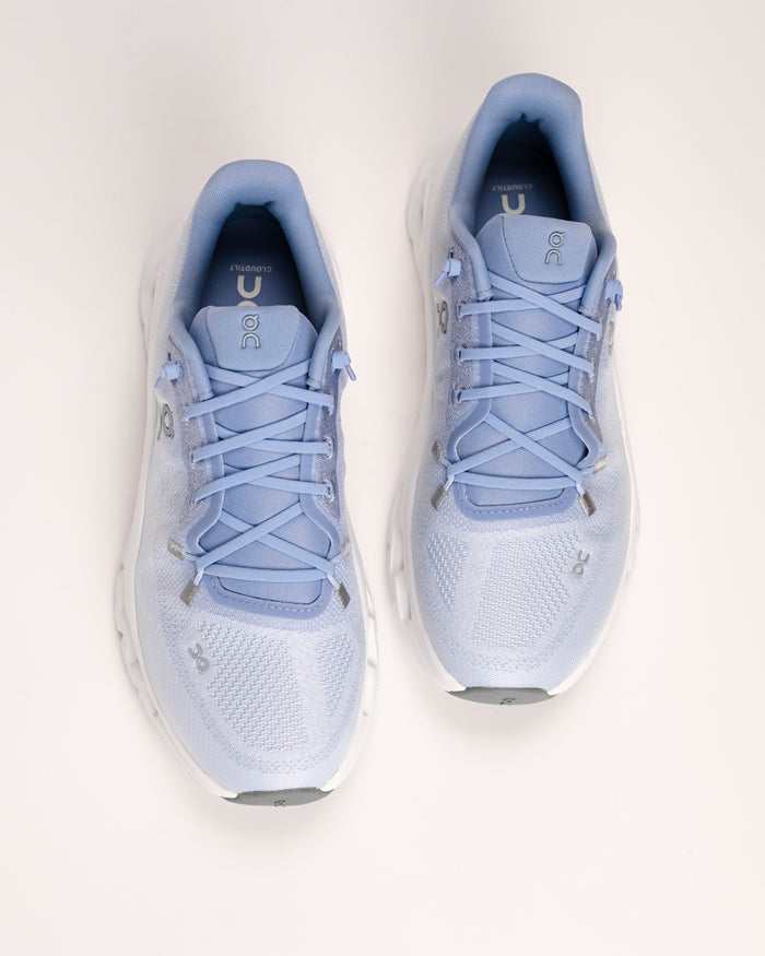 Overhead view of a pair of light blue Women’s On Cloudtilt lifestyle sneakers on a white background