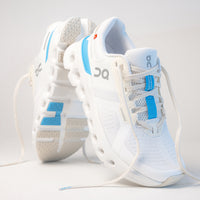 Dynamic shot of the Women's Cloudrunner 2 in White, showing an outsole updated to keep stones from getting trapped.