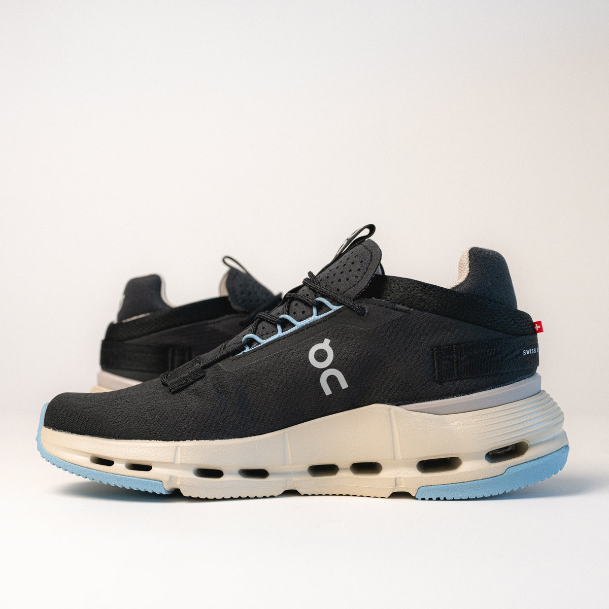 Side profile of the On Running Cloudnova 2 Sneaker in Black, featuring the Speedboard® and Zero-Gravity foam midsole for support and a smooth ride.