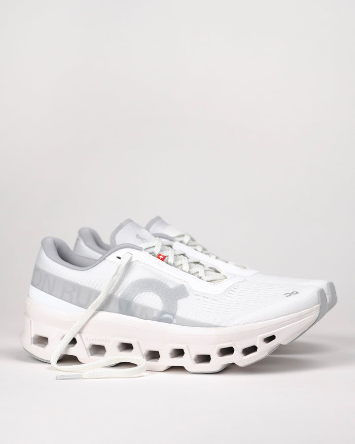Side profile of women’s On Cloudmonster 1 All White running shoe with oversized CloudTec® cushioning