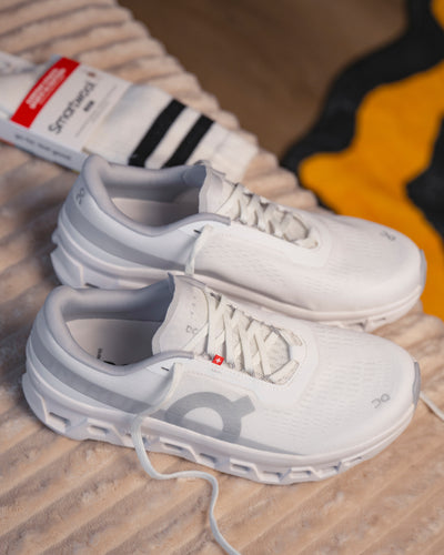 Top‑down view showing mesh upper and plush sockliner of On Cloudmonster 1 women’s runner with Smartwool sock