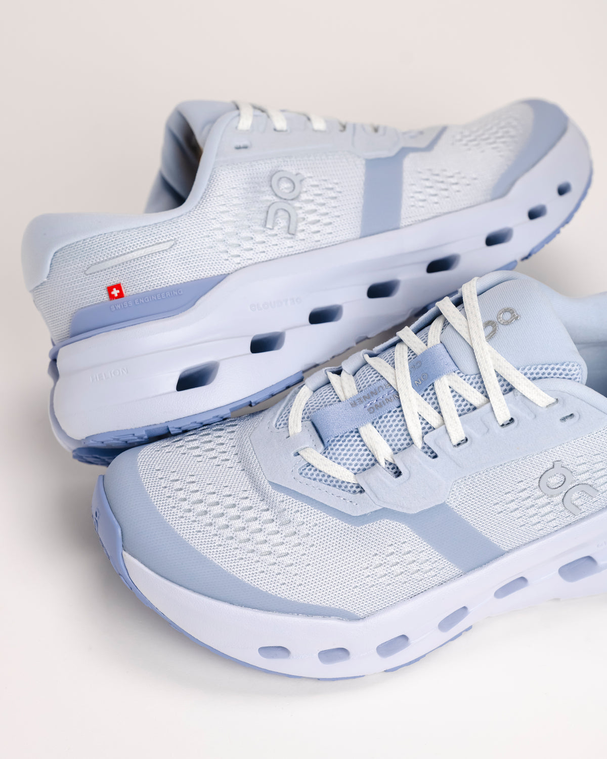 Pair of light blue On Cloudrunner 3 road running shoes on a white background