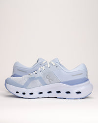 Light blue On running shoes on a white background focusing on the upper and midsole details