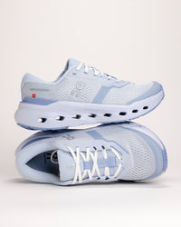 Stacked pair of light blue On Cloudrunner 3 athletic shoes on a white background