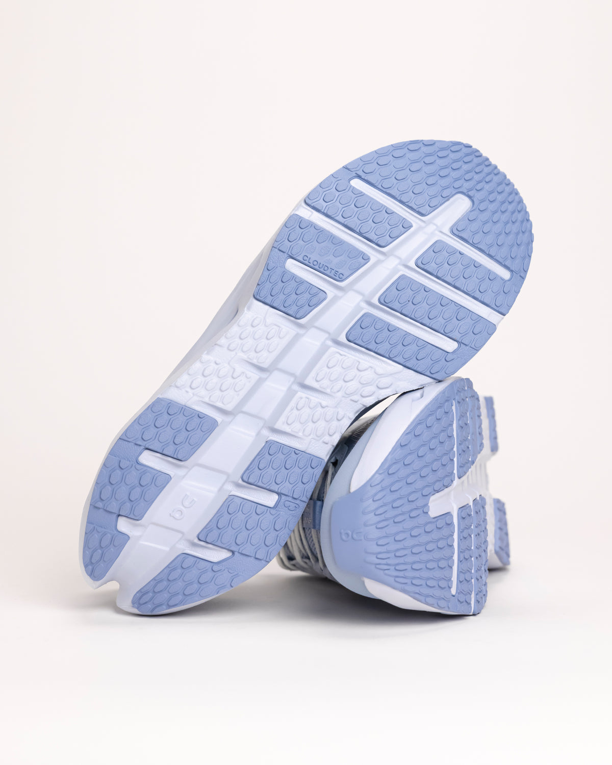 Close-up of a On Cloudrunner 3 shoe with blue and white sole on a light gray background