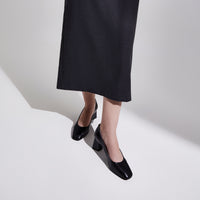 A woman wearing the Cass - Ayelet by Naot pump, showcasing the sophisticated, elevated style of the square-toe design and comfortable block heel that complements any outfit.