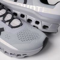 Close-up of the Men's On Running Cloudmonster breathable upper in Alloy/Silver, showcasing lightweight mesh for optimal ventilation and secure comfort during runs.