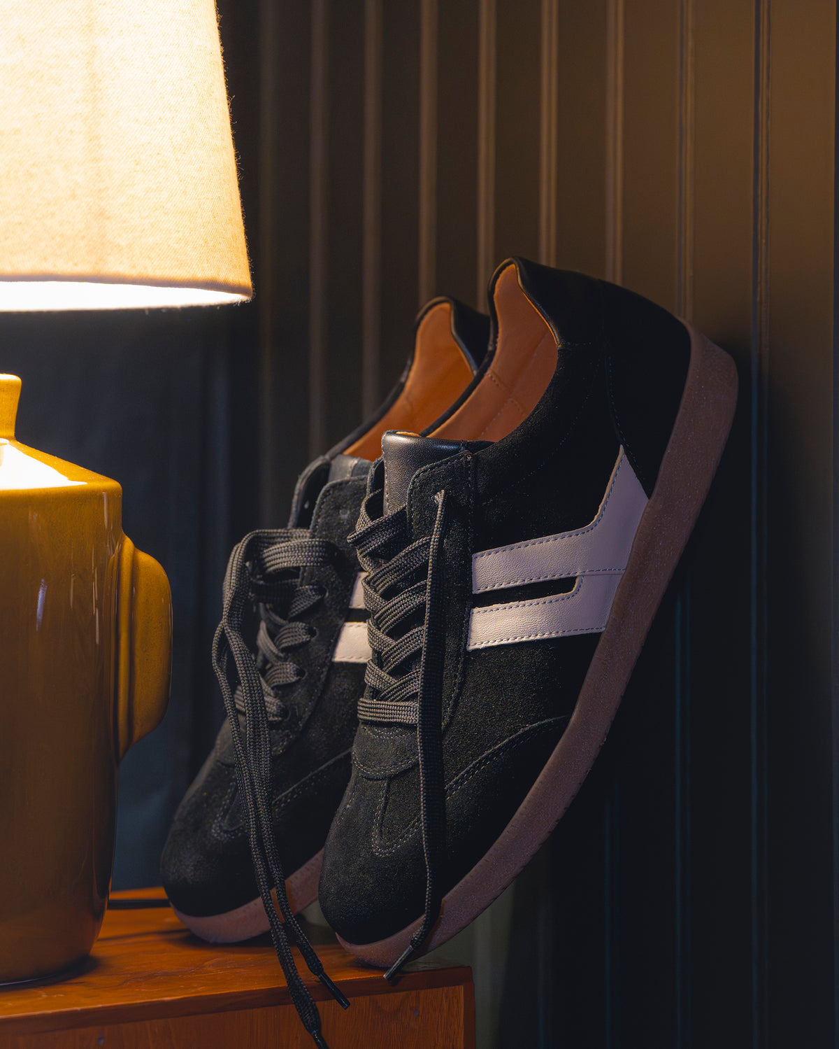 Gabor City Sneaker 73.300.17 in Black propped up in a dark moody room