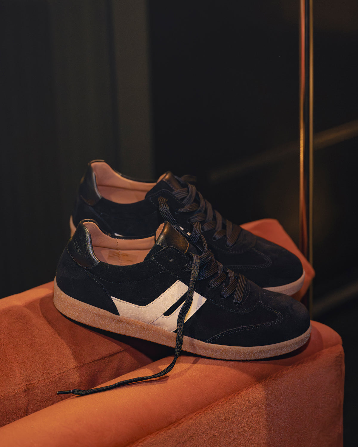 Women's Gabor City Sneaker 73.300.17 in Black on a velvet sofa