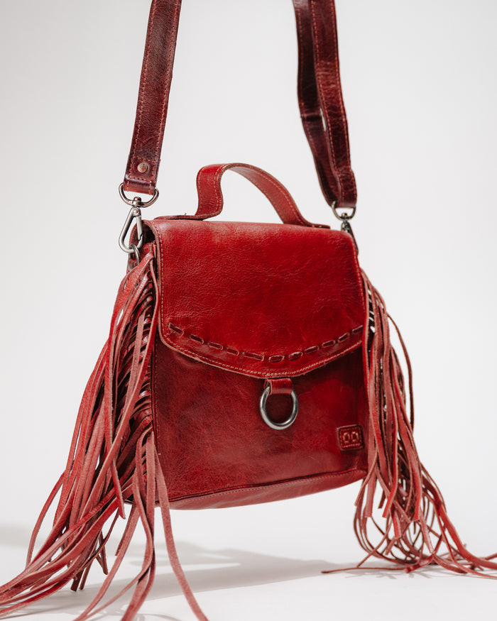 Side view of Bed|Stü Hidden leather fringe crossbody bag showing top handle and adjustable strap
