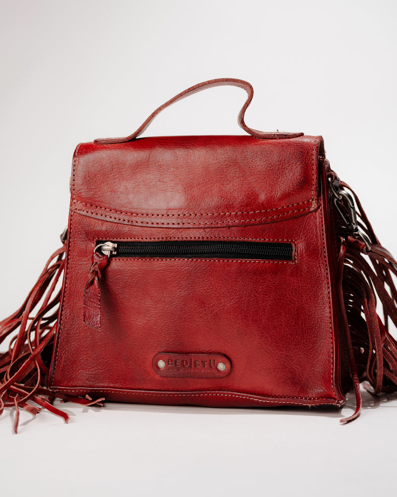 Back side view highlighting back zipper pocket and logo badge on Hidden leather bag