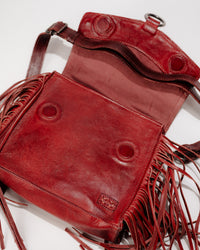 Detail shot of magnetic flap closure and stitching on leather Hidden bag