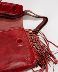 Detail shot of magnetic flap closure and fringe on leather Hidden bag