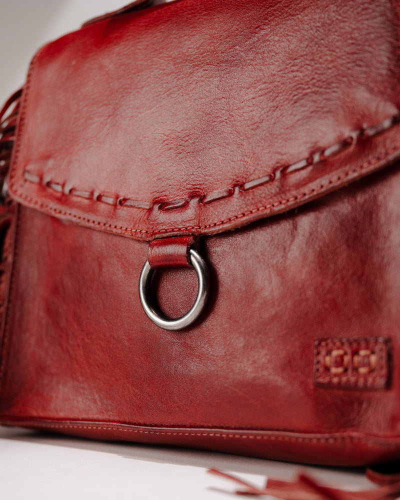 Detail shot of magnetic flap closure, stitching, and O-ring on the leather Hidden bag