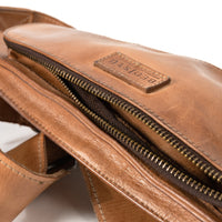 Detail view of the BED|STU Adept Crossbody Bag, featuring organized compartments for essentials and handmade one-of-a-kind finishes. Tan DD is made from chrome and formaldehyde-free, vegetable-tanned leather.