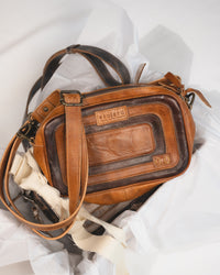 Front view of Bed|Stü Shy compact leather crossbody bag showing rectangular shape and leather overlays in a gift box