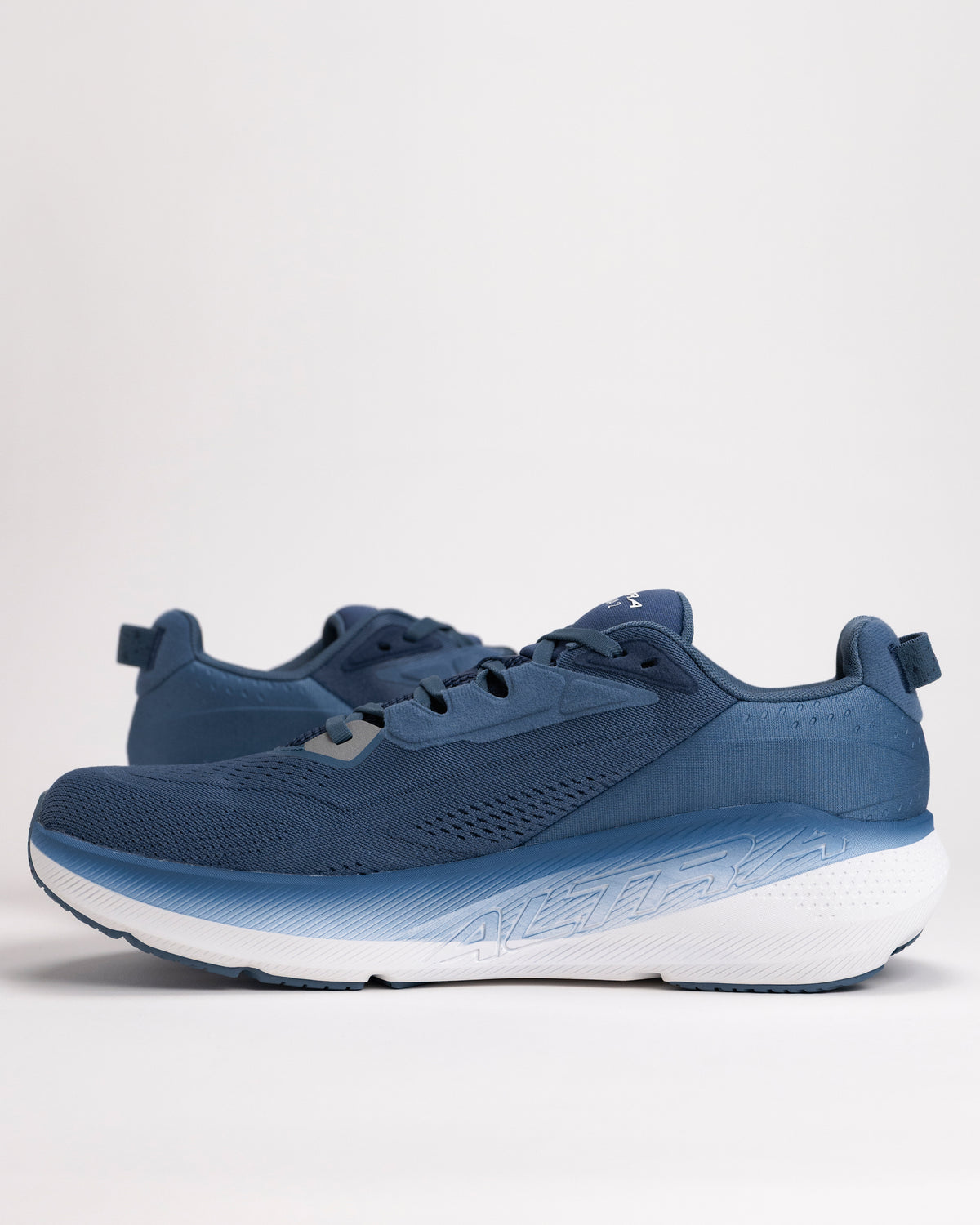 Close-up of plush Altra FWD VIA 2 neutral trainer showing engineered mesh upper in navy