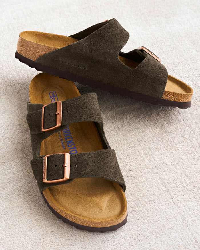 Neutral two-strap Arizona sandals in dark brown Mocha suede with copper buckles featuring the Birkenstock soft cushioned footbed, comfortable for all-day wear. Birkenstock style number, 951311 