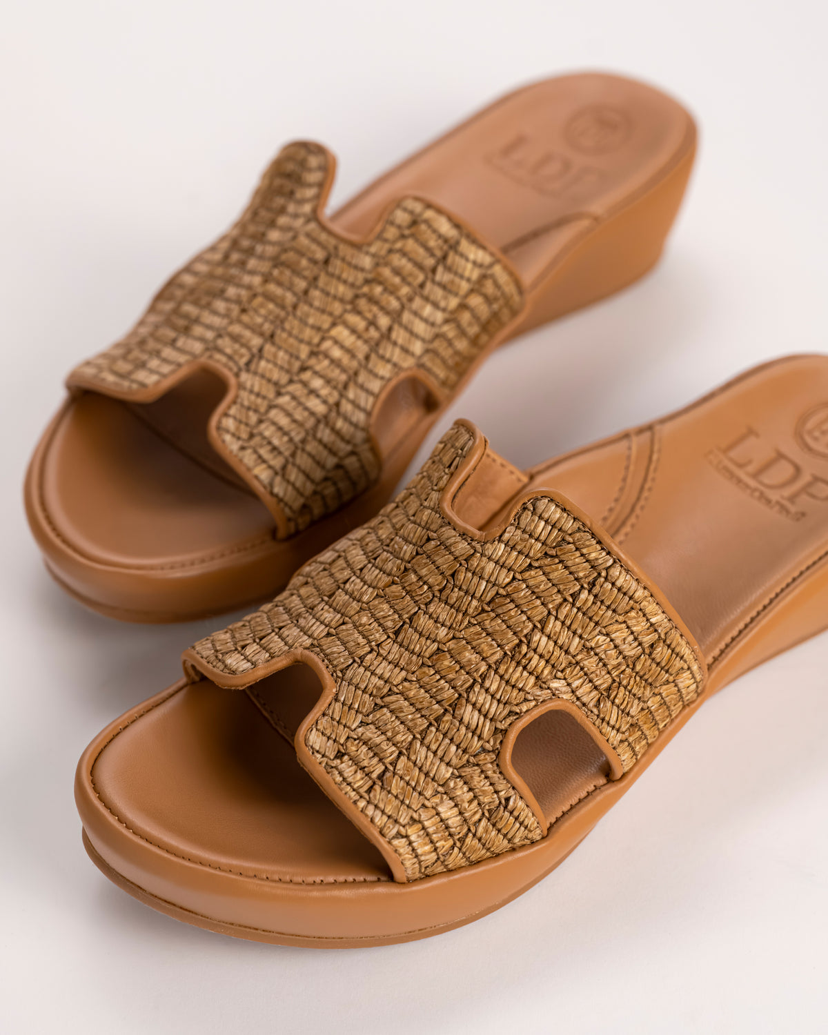 Close-up of woven raffia texture on Catian Slide sandal.