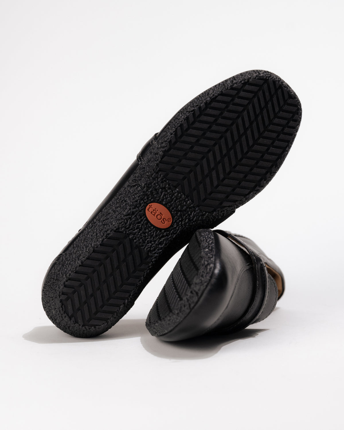 Bottom view of the Women’s Taos Gabby Loafer – Soft Leather Slip-On in Black showing rubber traction pattern