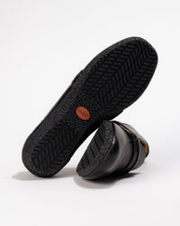 Bottom view of the Women’s Taos Gabby Loafer – Soft Leather Slip-On in Black showing rubber traction pattern
