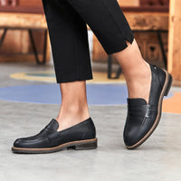 Front detail view. ALDAYA Penny Wide black leather loafers featuring a sleek calfskin leather upper, extra wide fit, and 3 cm thick synthetic sole. Classic penny loafer design with a modern twist, perfect for pairing with skirts, trousers, or dresses. Extra comfort with a removable insole and soft pigskin-textile lining.