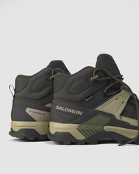 Back angle highlighting ankle collar, GORE-TEX and logo details, and heel design of Salomon trail boot