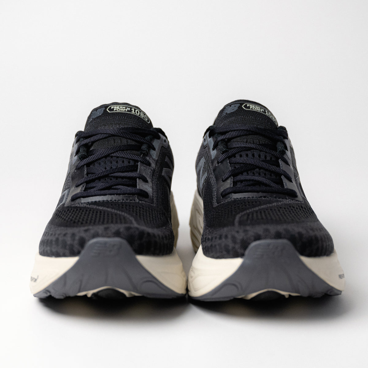 Front view of Men's New Balance Fresh Foam X 1080 V14 in Black/Magnet, showcasing the secure lace-up design and padded tongue.