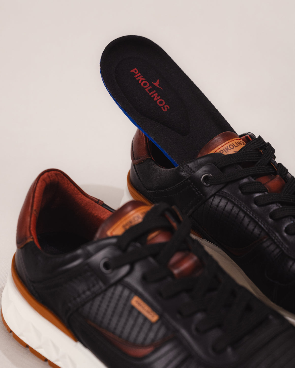 Lightweight black leather lace-up trainer with memory foam footbed