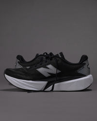 Black running shoes with white sole on a gray background
Men’s New Balance FuelCell Rebel v5 in Black/White – Lightweight Neutral Trainer