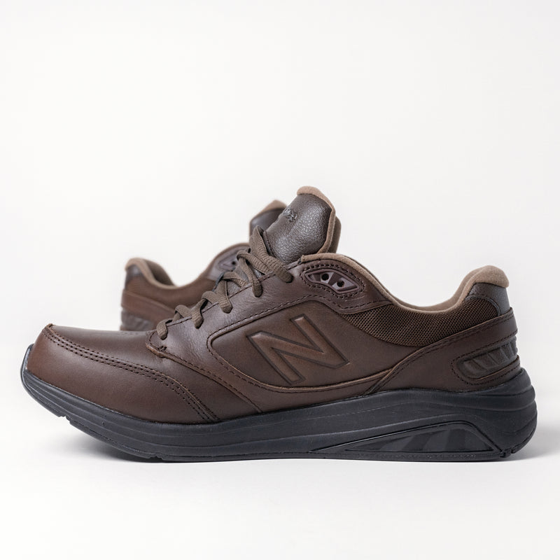 Side profile of the men's New Balance 928 V3 walking shoe in brown leather.