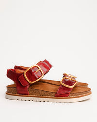 Red leather Taos On The Double sandals with cork sole on a white background