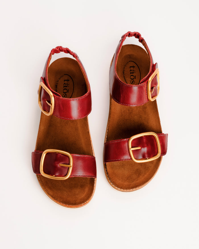 Red leather Taos On The Double sandals with cork sole on a white background