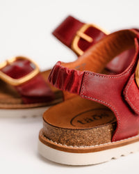Red leather Taos On The Double sandals with cork sole on a white background