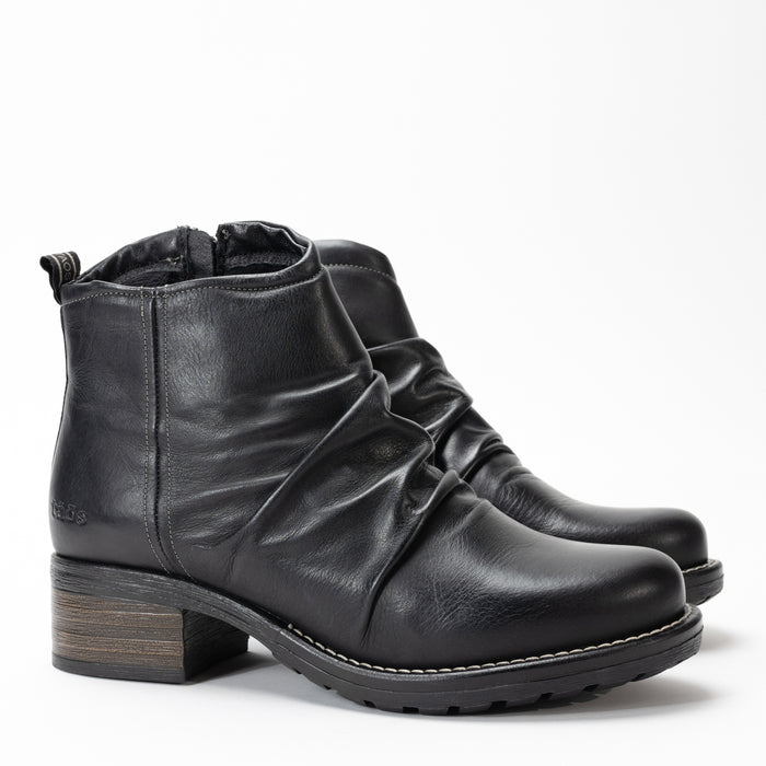 Side view of Women's Taos Ravelle bootie with burnished black leather finish.