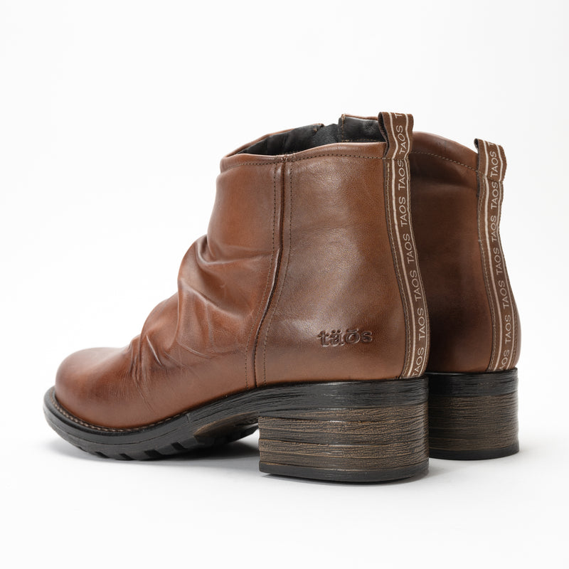 Lightweight rubber sole and stylish 2" heel on the Taos Ravelle bootie. Logo detail ribbon pull-tab on back.