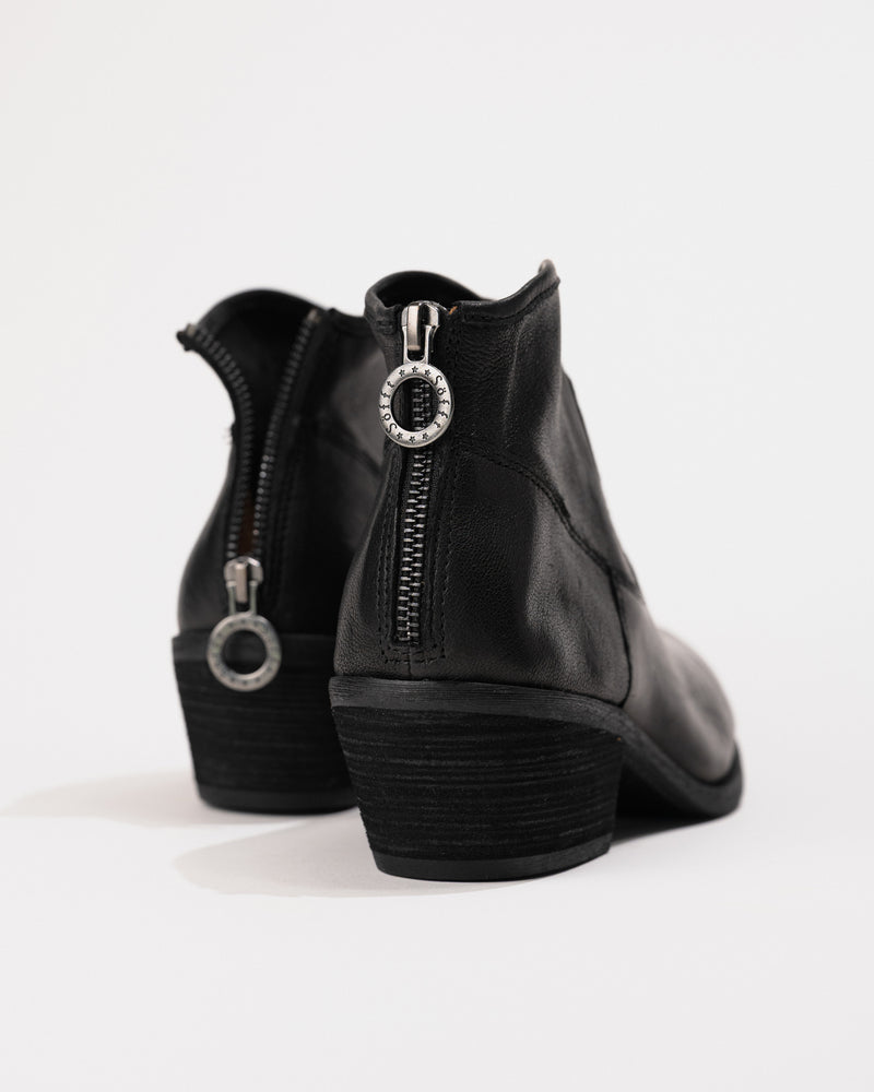 Close-up of back zipper with ring pull for signature western-inspired detail.