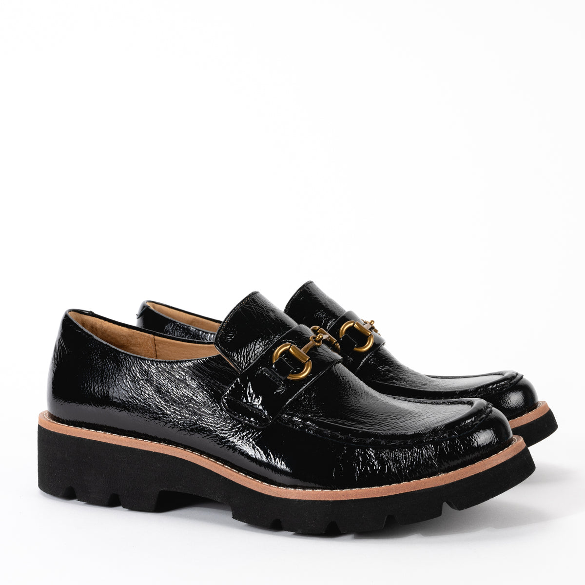 Side view of Sofft Prewitt black patent leather loafer, featuring a chunky lugged outsole and a brushed metal horsebit ornament for a modern look.