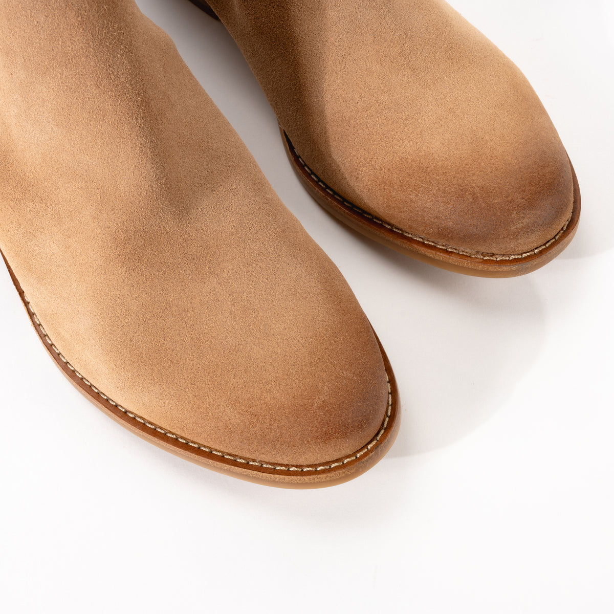 Close-up of the toe detail on Sofft Angelica bootie, showing the finely hand-finished Desert tan suede for a polished yet rugged look.