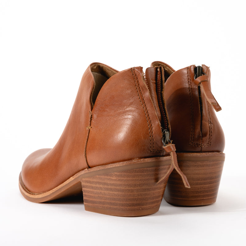 Back zipper detail view of Sofft Angelica bootie in luggage brown, showcasing functional heel zipper, cushioned, leather-lined footbed with arch support for comfort in all weather, and 2 inch stacked heel.