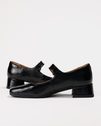Side angle showcasing buckle strap and exterior silhouette.