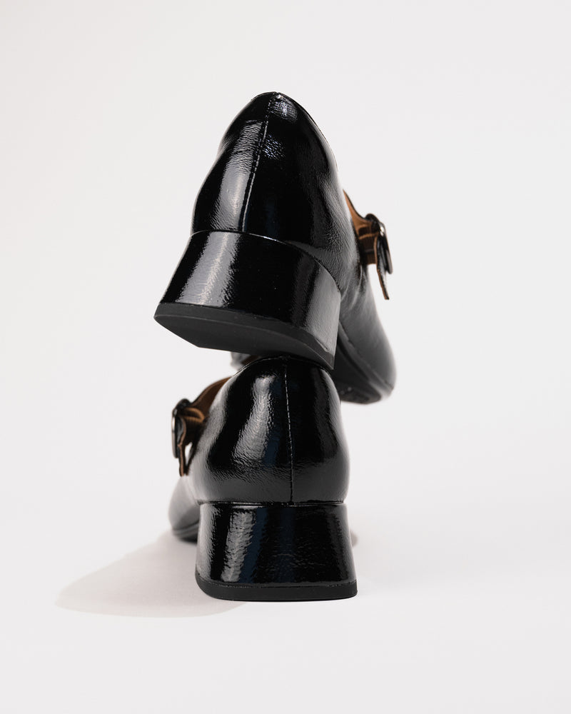 Close-up highlighting the wrapped blocky heel and glossy patent finish.