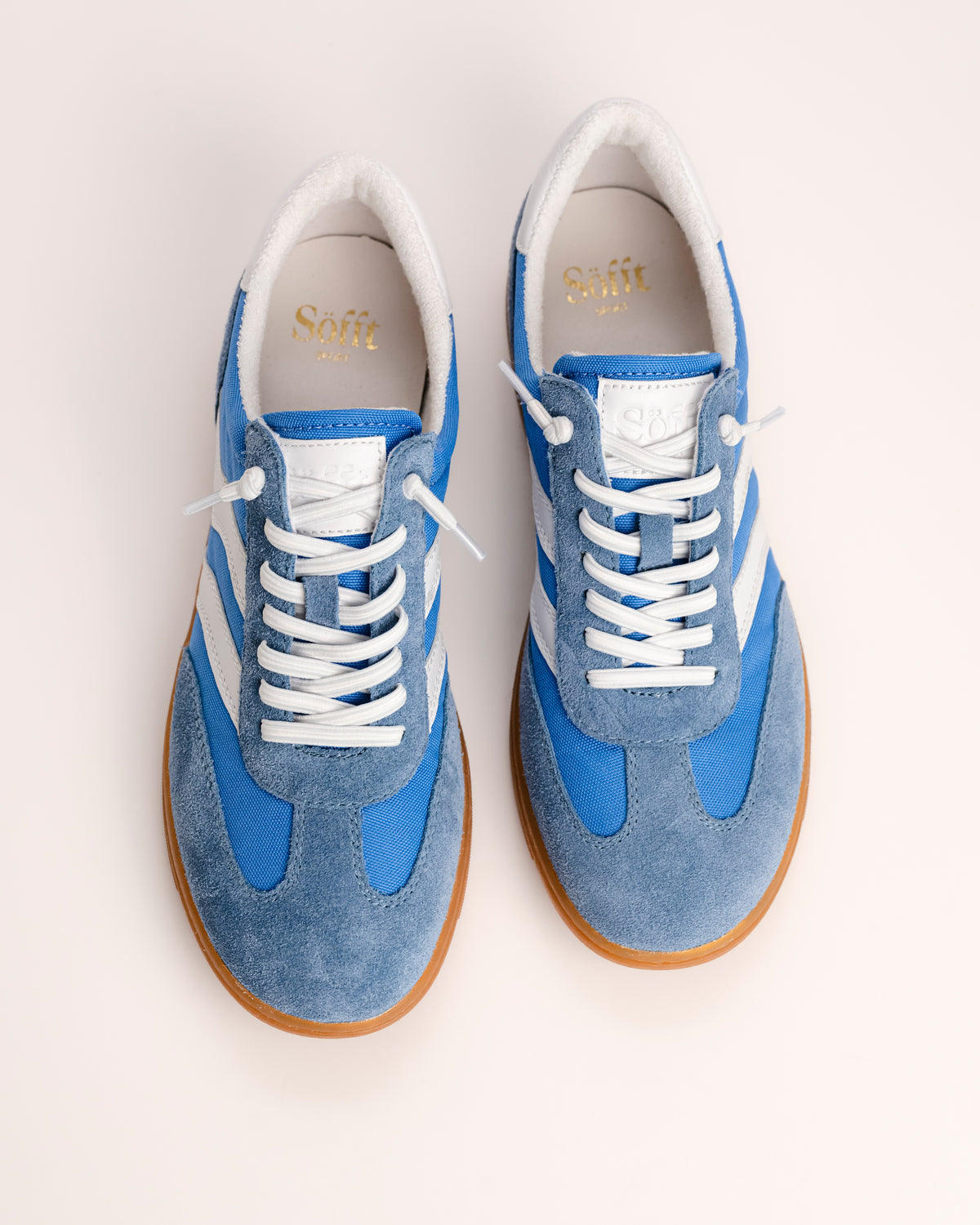 The Sofft Remmi in Blue is a fresh take on the classic retro runner, blending a vintage athletic silhouette with sophisticated, modern materials. Crafted from premium Italian suede with tonal nylon or fabric accents, this low-top sneaker features sporty contrast side stripes that give it an instant style refresh. It’s designed specifically for a lightweight feel, making it a go-to choice for transitioning your wardrobe into spring and summer.