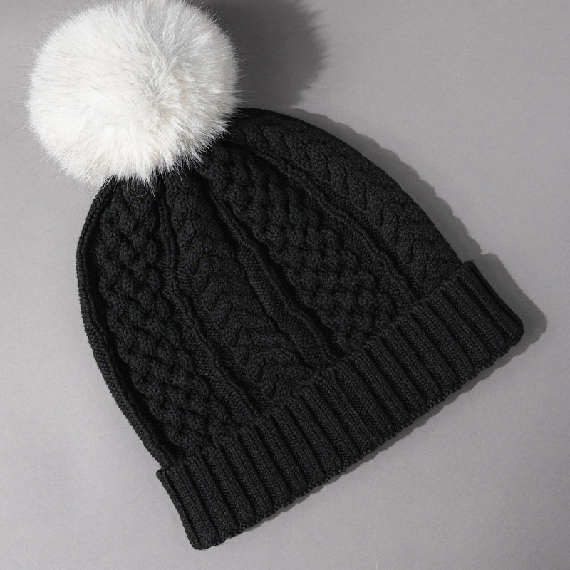 Back overhead view of the Women's Smartwool Lodge Girl Soft Merino Knit Beanie with Faux Fur Pom in Black and Gray