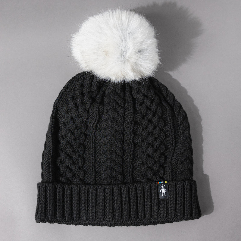 Front view of the Women's Smartwool Lodge Girl Soft Merino Knit Beanie with Faux Fur Pom in Black and Gray