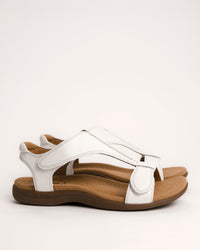 Women's Taos sandals. The Show comfort sandal features a premium white leather upper, adjustable straps, and a contoured cushioned footbed with arch support for all-day wear.