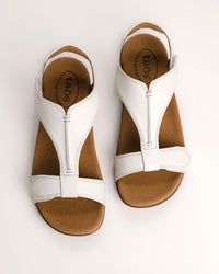 Women's Taos sandals. The Show comfort sandal features a premium white leather upper, adjustable straps, and a contoured cushioned footbed with arch support for all-day wear.